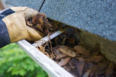 Cleaning gutter in Rancho Mission Viejo, CA.